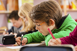 Boy Writing In Class