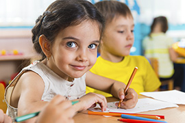 Girl Doing Schoolwork and Smiling